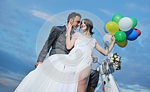Just married couple ride white scooter