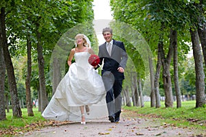 Just Married Couple Walking Fast Down The Path