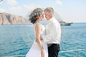 A Just married couple on yacht. Happy bride and groom on their wedding day