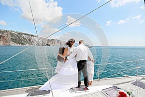 Just married couple on yacht. Happy bride and groom on their wedding day