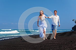 Just married happy family on tropical island honeymoon holidays