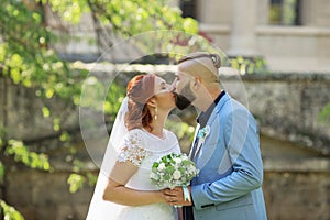 Just married loving hipster couple in wedding dress and suit in