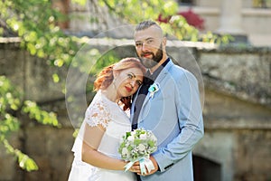 Just married loving hipster couple in wedding dress and suit in