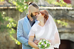 Just married loving hipster couple in wedding dress and suit in