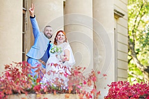 Just married loving hipster couple in wedding dress and suit in