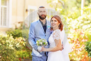 Just married loving hipster couple in wedding dress and suit in