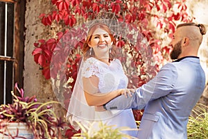 Just married loving hipster couple in wedding dress and suit in