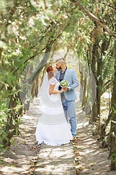 Just married loving hipster couple in wedding dress and suit in