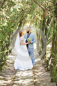 Just married loving hipster couple in wedding dress and suit in