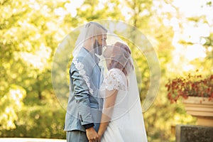 Just married loving hipster couple in wedding dress and suit in