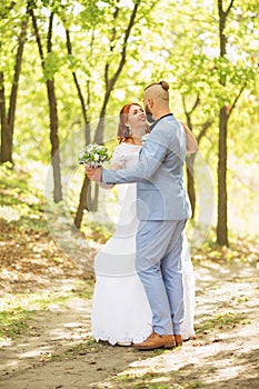 Just married loving hipster couple in wedding dress and suit in