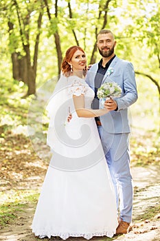 Just married loving hipster couple in wedding dress and suit in