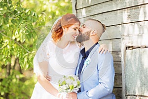 Just married loving hipster couple in wedding dress and suit in