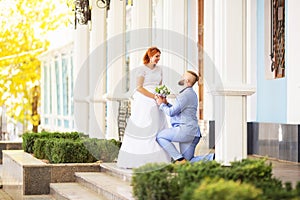 Just married loving hipster couple in wedding dress and suit in