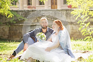 Just married loving hipster couple in wedding dress and suit in