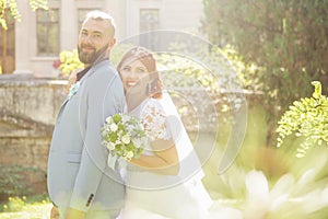 Just married loving hipster couple in wedding dress and suit in