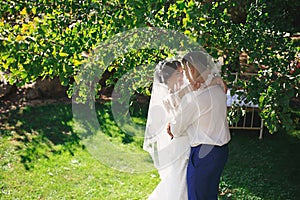 Just married loving hipster couple in wedding dress and suit in