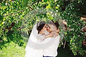 Just married loving hipster couple in wedding dress and suit in