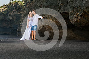 Just married loving man and woman embracing on sea beach
