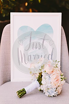 Just married sign with wedding bouquet