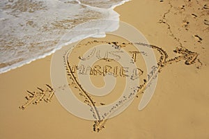 Just married written in sand
