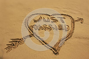Just married written in sand