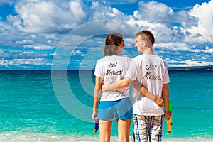 Just married young happy loving couple having fun on the tropical beach