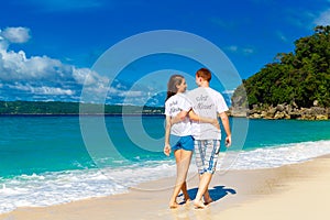 Just married young happy loving couple having fun on the tropical beach