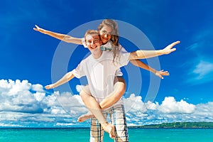 Just married young happy loving couple having fun on the tropical beach