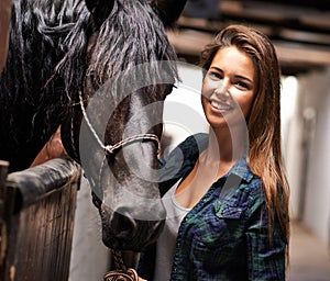 Just me and my horse. A young woman in a stable with her horse.