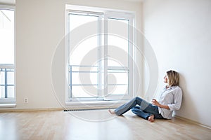 Just moved in: beautiful young woman finally sitting down