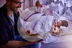 Just one more story daddy. Shot of a father reading a bedtime story to his daughter.