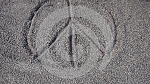 Just painted peace sign on a coarse-grained sand