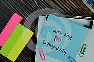 Just Say NO To Negativity write on sticky notes isolated on Wooden Table. Motivation concept