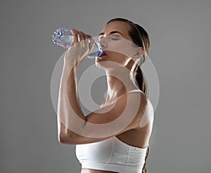 Just a sip, then back to work. a woman rehydrating during a strenuous workout.