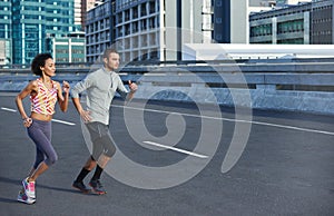 Just a step quicker. two friends jogging together through the city streets.