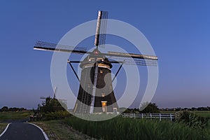 Just after sunset the lights are lit in this inhabited mill in Stompwijk Molendriegang Stompwijk, the Netherlands