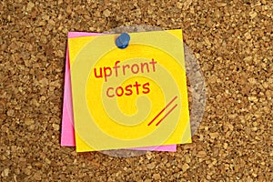 Upfront costs postit on cork photo