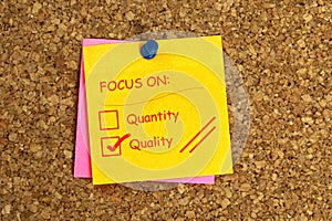 Focus on quantity quality postit on cork