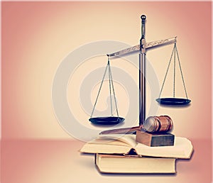 Justice Scales, books and gavel on wooden table