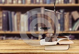 Justice Scales, gavel and books on light