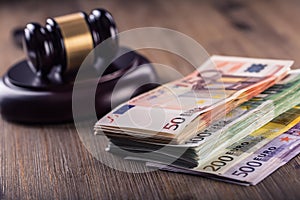 Justice and euro money. Euro currency. Court gavel and rolled Euro banknotes. Representation of corruption and bribery in the judi