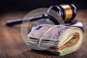 Justice and euro money. Euro currency. Court gavel and rolled Euro banknotes. Representation of corruption and bribery in the judi