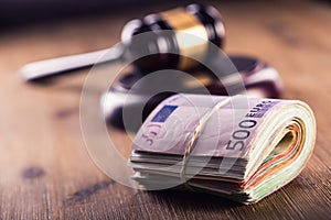 Justice and euro money. Euro currency. Court gavel and rolled Euro banknotes. Representation of corruption and bribery in the judi