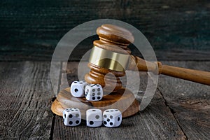 Justice gavel and dice on the background of an old wooden table