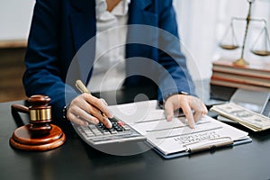 justice and law concept.businessman or lawyer or accountant working on accounts using a smart phone laptop digital tablet