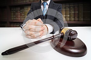 Justice and law concept. Lawyer with clasped hands and gavel in front