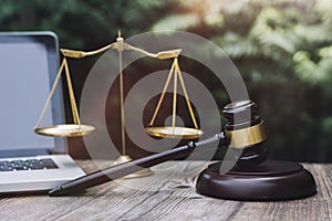 Justice and law concept.Male judge in a courtroom with the gavel, working with, computer and docking keyboard, eyeglasses, on