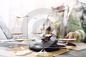 Justice and law concept.Male judge in a courtroom with the gavel, working with, computer and docking keyboard, eyeglasses, on