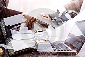 Justice and law concept.Male judge in a courtroom with the gavel, working with, computer and docking keyboard, eyeglasses, on